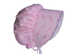 This beautiful baby bonnet will look adorable on your little girl and the wide brim offers some shade from the sun, and it can be folded back on less sunny days for a different look. It would be wonderful for your own little girl, or a perfect and unique gift for baby, toddler and little girl. **This bonnet fits pretty true to the age of baby if she is of average size** I made this sunbonnet with lightweight, preshrunk, cotton polyester pink eyelet fabric with pretty embroidery for the main bonnet, and inside the brim is white cotton fabric making an original little hat for spring, summer and fall. It has a full back with elastic for a comfy fit, and a little extra fabric at the back of the neck for added sun protection. There is interfacing in the brim to give it a nice shape, and it come Cute Pink Cotton Bonnet, Cute Pink Bonnet With Curved Brim, Pink Cotton Bonnet For Spring, Adjustable Pink Bonnet As Gift, Cute Pink Bonnet For Spring, Spring Adjustable Bonnet, Adjustable Spring Bonnet Cap, Pink Bonnet For Spring, One Size Fits Most, Spring Pink Bonnet, One Size Fits Most