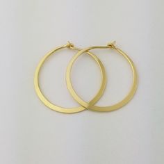 Gorgeous Solid 18k Hoops made from 16 gauge (1.3mm) wire.  The wire is hammered to nearly flat for a beautiful bold look.  Due to the handmade nature of these hammered earrings, there may be very slight surface inconsistencies rather than a fully flat 'machined' style surface.1" Size photographed; 2" size in 14k yellow gold shown in videoMETAL: Solid 18k Yellow GoldWIRE GAUGE/DIAMETER: 16 gauge (1.3mm) wire - Currently the thickest wire I offerEAR WIRE THICKNESS: Due to the thickness of the wire Minimalist Hallmarked Hoop Jewelry, Dainty Recycled Gold Round Hoop Earrings, Dainty Recycled Gold Hoop Earrings, Elegant Hand Forged Circle Earrings, Dainty Hallmarked Hoop Earrings Gift, Classic Hoop Earrings In Recycled Gold, Hand Forged Round Earrings For Anniversary, Elegant Hand Forged Round Hoop Earrings, Small Hoop Yellow Gold Earrings As Gift