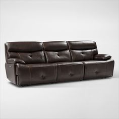 a brown leather couch with two recliners sitting on it's back end