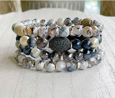 A blend of black, dark blues, and white in this 4 stack of essential oil diffuser bracelets. Apply your favorite essential oils to central lava bead and let it work its magic! Essential Oil Bead Bracelets, Essential Oil Diffuser Bracelet, Diffuser Bracelets, Lava Bead, Essential Oil Diffuser, Oil Diffuser, Jewelry Diy, Essential Oil, Essential Oils