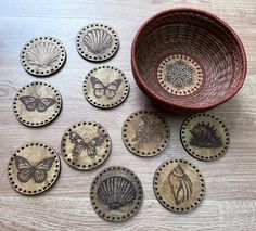 a wooden bowl filled with lots of different types of coasters on top of a table