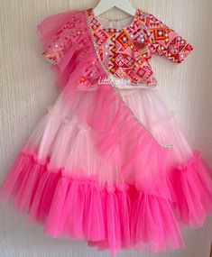 ✨ Dress your little princess in this stunning bubblegum lehenga for baby girl, designed to make her look adorable and stylish on any special occasion.  ✨ This beautiful outfit consists of a lehenga blouse and chunni, both adorned with intricate and beautiful patterns that add to its overall charm. The skirt and top of the outfit are fully lined, providing a comfortable and soft texture against your baby girl's delicate skin. The lehenga blouse is designed with an attractive neckline and a comfortable fit, perfect for your little one to wear all day long. ✨ The beautiful bubblegum color of the lehenga adds a touch of elegance and style to the overall outfit, while the intricate patterns and embroidery make it a true work of art. This beautiful outfit is perfect for any special occasion, inc Festive Princess Style Multicolor Dresses, Princess Style Multicolor Festive Dress, Festive Multicolor Princess Dress, Party Lehenga With Ruffles For Navratri, Pink Anarkali Skirt Set For Party, Fitted Bollywood Style Pink Skirt Set, Fitted Bollywood Pink Skirt Set, Pink Party Choli With Ruffles, Festive Ruffled Skirt Set