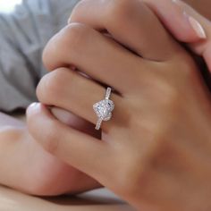 a woman's hand with a diamond ring on it