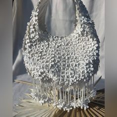 This Darling White Flower Purse Is A Perfect Entrance Into The Spring! Perfect For Your Next Vacation Or Night Out. Delicate And Charming, One Of A Kind, It Is Entirely Covered With Dimensional White Flowers. The Beaded And Flowerette Tassels Take This Design To The Next Level With Its Fun Girly Charm. Its Truly So Well Made And Designed. Spacious Bag Will Hold A Cell Phone, Wallet And Make Up For Touch Ups. Size: From Top Of Strap To Bottom Of Bag 10in Zipper To Bottom Of Bag 5.5in Across 8.5in Elegant Flower Shaped Shoulder Bag For Daily Use, Elegant Flower-shaped Shoulder Bag For Daily Use, Elegant Flower Shoulder Bag For Everyday Use, Elegant Flower Shaped Shoulder Bag For Everyday Use, Elegant Flower-shaped Shoulder Bag For Everyday Use, White Spring Bag With Pearl Handle, White Spring Bags With Pearl Handle, Spring White Bag With Pearl Handle, Elegant Spring Flower-shaped Bag