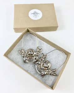 "These earrings are made from a vintage silver dish which had a beautiful embossed around the edge of flowers and other art nouveau motifs. I followed the line of the pattern into a point, drilled it and attached a sterling silver ear wire which is attached to either side of the charm. One side is hooked and unloops from the other side for you to insert the ear wire, and then clip it back up. They are very lightweight but are so eye catching. Measurements: Charm Length: 53 mm / 2.08\" Charm Widt Vintage Pierced Hoop Earrings For Wedding, Vintage Metal Flower Earrings For Gift, Antique Silver Engraved Earrings For Gift, Antique Silver Engraved Earrings Gift, Vintage Silver Earrings For Gift, Victorian Engraved Earrings For Gifts, Vintage Engraved Earrings For Gift, Vintage Small Hoop Silver Jewelry, Vintage Silver Small Hoop Jewelry