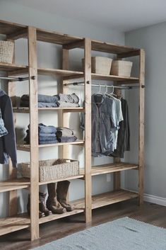 an organized walk - in closet with wooden shelves and baskets