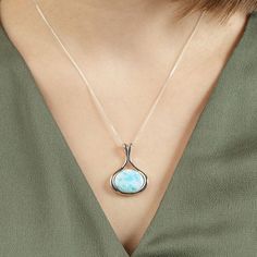 Divine Beauty of Larimar The divine beauty of the sky and the mysteries of the sea are perfectly captured in this stunning Mermaid Necklace - Larimar Crystal Pendant. Accented with a cushion-cut Larimar gemstone this necklace will surely make a lasting impression. Classic, timeless, yet so unique, just like you. Unique and Spiritual Stone The Larimar stone used in each piece has its own pattern and contains different hues, varying from light blue to blue-green, making each and every necklace tot Elegant Larimar Pendant Jewelry, Spiritual Larimar Gemstone Necklace, Mystical Oval Gemstone Necklace, Mystical Jewelry For Meditation, Spiritual Larimar Pendant Jewelry, Spiritual Round Larimar Jewelry, Mystical Healing Necklace With Cabochon, Elegant Larimar Jewelry, Attract Good Energy