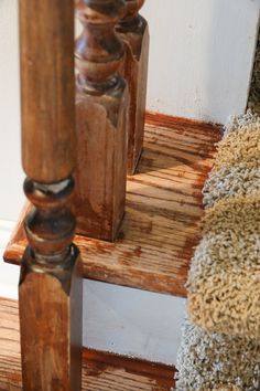 an old wooden stair case with carpet on the bottom