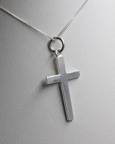 Beautiful simple and elegant sterling silver cross.  The cross measures 3cm in length by 1.5cm in width and hangs on a sterling silver curb chain (please choose desired length from drop-down menu). Wrapped in tissue paper and presented in an organza pouch. Upgrade to box available in shop. Minimalist Silver Cross Necklace, Simple Sterling Silver Cross Pendant Necklace, Minimalist Sterling Silver Cross Necklace, Everyday Sterling Silver Crucifix Necklace, Minimalist Sterling Silver Crucifix Necklace, Minimalist Sterling Silver Cross Pendant Necklace, Minimalist White Gold Sterling Silver Cross Necklace, Minimalist Sterling Silver Pendant Cross Necklace, Pendant Minimalist