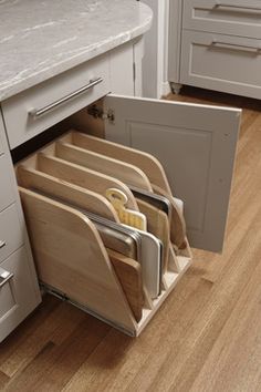 an open drawer in the middle of a kitchen