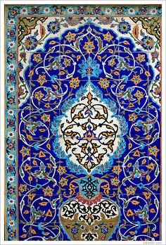 an intricately designed carpet with blue and orange colors