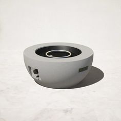 a white speaker sitting on top of a marble floor