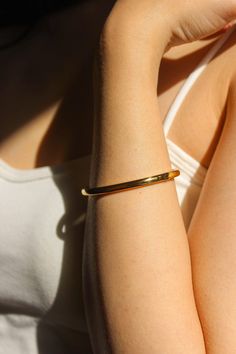 PRODUCT DESCRIPTION Golden simplicity. This piece is a minimalist statement piece for any look. The Ava Plain bangle celebrates the beauty of expert craftsmanship. Formed from polished titanium steel and coated with gleaming 18-karat gold for an opulent finish, this bangle adds a suave touch to your wrist – whether worn alone or stacked alongside your favourite timepiece. A must-have addition to your jewellery addition. Signature Gold Bangle Water Resistant 18k Gold-plated on titanium steel One Everyday Gold Timeless Cuff Bracelet, Timeless Gold Cuff Bracelet For Everyday Wear, Classic Gold Stainless Steel Cuff Bracelet, Classic Stainless Steel Bracelet For Everyday Wear, Gold Minimalist Cuff Bracelet Tarnish Resistant, Minimalist Gold Cuff Bracelet, Tarnish Resistant, Gold Minimalist Tarnish-resistant Cuff Bracelet, Minimalist Tarnish Resistant Gold Cuff Bracelet, Modern Gold Stainless Steel Cuff Bracelet