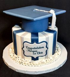 a graduation cake with a blue cap on top