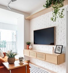 a flat screen tv mounted to a wall in a living room