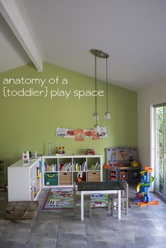 an empty play room with toys on the floor