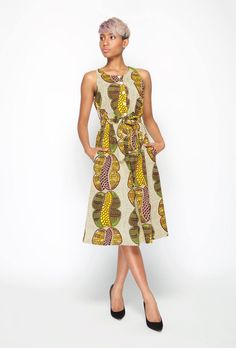 "This sleeveless A - line shaped print dress, is made with quality Dutch Hollandaise Cotton print, also known as African print. It features, front upper bodice button stand, inverted pleat bottom skirt, side pockets, elastic waist with self tie belt. Dress length falls below knee length.  A timeless trans-seasonal cocktail dress suitable for all occasions. Made In Australia. Model wears a size: S and is 5ft 6\" tall Fabric:  100% Cotton Care: Cold hand wash with mild soap. Do not bleach/soak or Casual Sleeveless Printed Midi Dress, Casual Printed Sleeveless Midi Dress, Casual Sleeveless Maxi Dress With Abstract Print, Casual Sleeveless Midi Dress With Vibrant Print, Patterned Sleeveless Printed Dress, Sleeveless Patterned Dress With Abstract Print, Casual A-line Dress With Abstract Print, Sleeveless All Over Print Dress, Sleeveless Sundress With Abstract Print