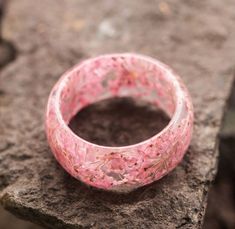 Unusual Ring made of Wood and Epoxy Resin with flowers Sakura| Handmade High Quality Wooden Beautiful Epoxy Ring| Unick Ring| Nature Ring Materials: wood,  jewelry resin, epoxy resin, dried flowers size: Inner diameter from 15 to 23 mm The Sakura ring is made of transparent resin and small pink dried flowers. Sakura blooms from the end of March, and until May, in different areas of Japan in different ways. This period is called Hanami -- admiring sakura. For the Japanese, cherry blossoms are a m Handmade Pink Nature-inspired Jewelry, Pink Flower-shaped Nature-inspired Jewelry, Pink Flower Nature-inspired Jewelry, Handmade Pink Flower-shaped Rings, Handmade Pink Flower Rings, Handmade Pink Flower Shaped Rings, Resin With Flowers, Sakura Ring, Epoxy Ring