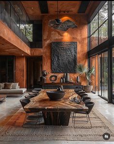 a large dining room table surrounded by chairs and tables with black vases on them