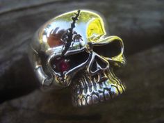 "Skull ring...ring is 1\" tall by 3/4\" across the top...carved in wax and cast in sterling silver...with a red C.Z. (cubic zirconia) in one eye...ring is in a size 12 and can be sized...great looking skull ring.." Skull Shaped Sterling Silver Ring In White Gold, Formal White Gold Skull Ring In Sterling Silver, Skull Shaped Symbolic Jewelry Stamped 925, Collectible Sterling Silver Skull Ring With Polished Finish, Sterling Silver Skull Jewelry Hallmarked, Gothic Skull Ring With Polished Finish Gift, Gothic Skull Ring With Polished Finish, Symbolic Skull Shaped 925 Stamped Jewelry, Unique Silver Skull Rings