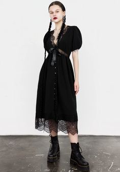 Mark the grave- Black midi dress with sheer lace panelling   - Classically flattering fit ‘n’ flare shape  - Short puff sleeves with elasticated hems for added volume - Lace-trimmed deep V-neck & hems  - Sheer lace waist panel follows the line of the underbust to emphasise your shape - Satin bow between neckline an Lace Button, Black Midi, Lace Crop Tops, Grunge Style, Satin Bow, Printed Denim, Black Midi Dress, Sheer Lace, Deep V Neck