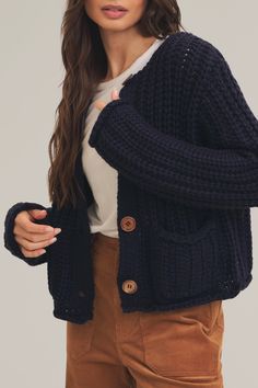 wrap yourself in comfort with this oversized chunky knit cardigan, designed for effortless style and warmth. featuring long sleeves, a relaxed fit, and natural wooden buttons, this sweater is perfect for layering over your favorite basics. its front pockets add a touch of practicality, while the round neckline keeps the look versatile. made for fall and winter, this knit cardigan is your go-to piece for cozy chic vibes. 100% acrylic model is 5'8.5" and wearing a size small Button Down Sweater, Thick Sweater, Thick Sweaters, Chunky Knit Cardigan, Cozy Chic, Wooden Buttons, Sweater Material, Romper With Skirt, Sweater And Shorts