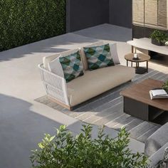 an outdoor living area with couches and tables