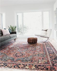 a living room filled with furniture and a large rug