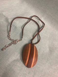 Turned wooden pendant Wooden Pendant Necklace For Gift, Brown Wooden Pendant Jewelry, Brown Wooden Necklace Gift, Brown Wooden Necklace For Gifts, Brown Wooden Necklace For Gift, Brown Wood Necklace As Gift, Brown Wooden Necklace Perfect For Gifts, Artisan Brown Necklace With Oval Pendant, Brown Wooden Beads Pendant Necklace