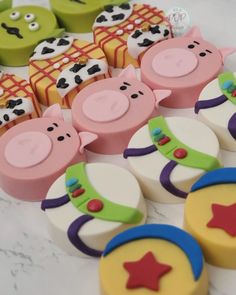 several decorated cookies are sitting on a table with farm animals and stars in the middle