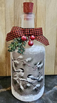 a frosted cake decorated with birds and pine cones