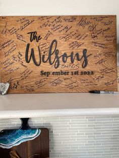 a wooden sign with writing on it that says the willows and is surrounded by shoes