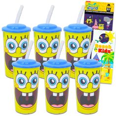 four yellow cups with blue lids and straws in front of an advertisement for spongebob