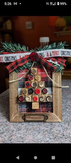 a christmas tree made out of wine corks on top of a wooden frame with ribbon