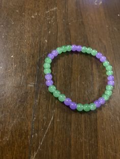 Handmade Purple and Green Bracelet Casual Hand-strung Purple Bracelets, Green Casual Stretch Bangle Bracelet, Bracelet Violet, Green Bracelet, Purple Bracelet, Purple And Green, Green And Purple, Arm Band, New Orleans