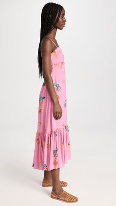 A beautiful pink midi dress in the fanciest of floral prints! This silhouette features a flowy skirt, smocked backing for secure fit, and an elegant keyhole back. The Rosie Posie Maxi Dress will allow you to easily transition from brunch to date night, or a romantic and comfortable fit during a European gateway trip! Composition & Fit: Lightweight Non-Stretch Soft Weave Fabric Removable Straps Smocked Elastic Back On-Seam Side Pockets Lined Shell: 100% Viscose Lining: 100% Viscose Hand wash Rosie Posie, Pink Midi, Bohemian Lifestyle, Pink Maxi, Cute Boutiques, Pink Midi Dress, Pink Maxi Dress, Flowy Skirt, Ribbon Trim