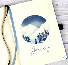 an open notebook with the word january written in blue ink and trees on it, next to a pen