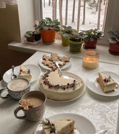 a table topped with cakes and cups of coffee