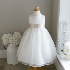 This Ivory Flower Girl Dress In Size 2t Is Breath Taking! The Sleeveless Dress Has A Luxurious Matte Satin Bodice (As In Bridal Gowns, Not Like Shiny Satin Sheets) That Zips In Back. The Flared Gathered Skirt Has An Ivory Organza Overlay. The Skirt Has Another Liner That Has A Large Crinoline Ruffle For Volume And Flare. The Luxurious Satin Sash Comes In A Champagne Hue And Is Done In A Cummerbund Style In The Front. The Back Ties Into A Long Flowing Bow For A Perfect Fit. Upper Zippered Back. G 2t Flower Girl Dress, Classic Flower Girl Dress, Flower Girl Dress Satin, Elegant Flower Girl Dress, Champagne Flower Girl, Flower Girl Dresses Champagne, Ivory Flower Girl Dress, Organza Overlay, Satin Flower Girl Dress