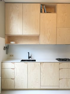 an empty kitchen with wooden cabinets and white counter tops, including a stove top oven