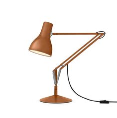 a desk lamp that is on top of a white surface with a cord attached to it