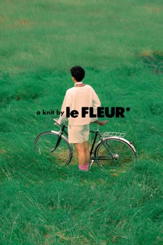 a person standing next to a bike in a field with the words, a knit by le fleur