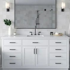 a bathroom vanity with two sinks and a large mirror