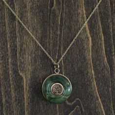 Jem's Jade Necklace Jade Amulet Pendant Necklace, Jade Amulet Necklace With Round Pendant, Green Necklace With Large Medallion Pendant, Green Oval Pendant Amulet Necklace, Spiritual Jade Round Pendant Necklace, Green Oval Pendant Necklace With Engraving, Green Oval Pendant Necklace Engraved, Jade Round Pendant Necklace For Healing, Spiritual Engraved Jade Necklace