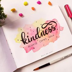 a notebook with the words kindness written on it next to some markers and pencils