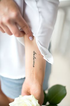 a woman with a tattoo on her arm that reads, i love you forever written in cursive writing