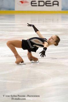 a female figure skating on an ice rink