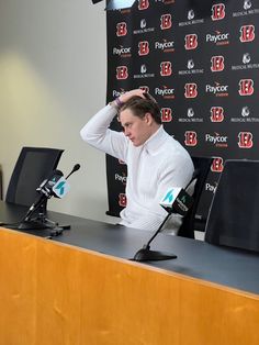 a man sitting at a desk with his head in his hands