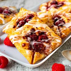 raspberry danish pastries with icing on a white plate