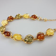 Multi colour Amber bracelet, gold plated Sterling Silver 925 bracelet with hallmarks. Adjustable resizable chain bracelet, gemstone bracelet. Will be just a stunning gif for her. Length : minimum 17,5- max 22.5 cm. Very elegant gemstone bracelet. Weight 11.39 gr. Stone size 1.2-1 cm. very small and cute. This bracelet is small - stones about 1.2 x 1 cm size. This item was made of natural Baltic Amber. All the amber used in my jewelry is collected in my home country Lithuania. I sell only genuine Adjustable Gold Gemstone Jewelry, Yellow Jubilee Bracelet, Yellow Gold-plated Gemstone Bracelet, Adjustable Amber Bangle Jewelry, Adjustable Gold-plated Crystal Bracelet As Gift, Gold-plated Round Beaded Bracelets As Gift, Gold Plated Beaded Bracelets As Gift, Gold Plated Round Beaded Bracelets For Gift, Round Gold-plated Beaded Bracelets As Gift